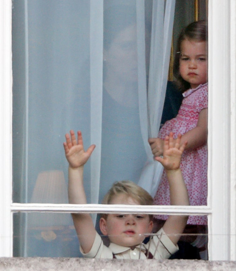 Prince George of Cambridge and Princess Charlotte of Cambridge watch from a window of Buckingham Palace during the annual Trooping the Colour Parade on June 17, 2017