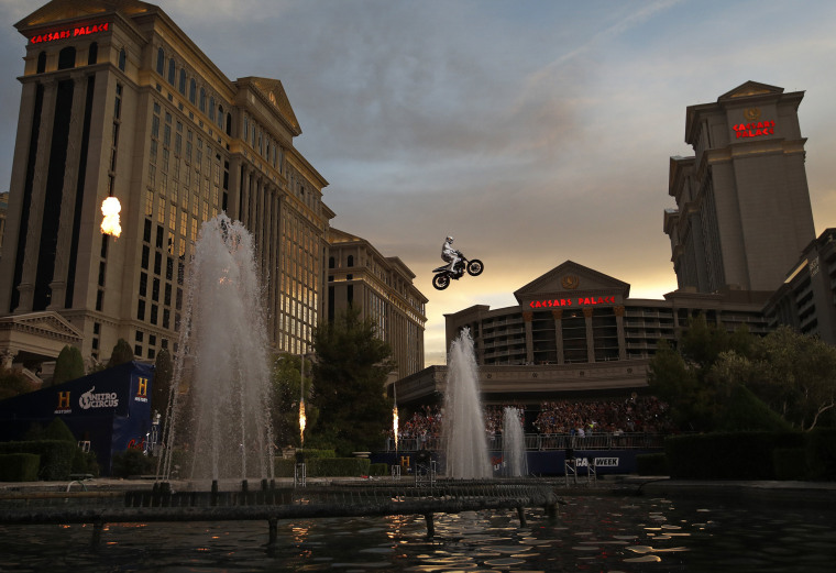 Image: Travis Pastrana jumps the fountain at Caesars Palace on a motorcycle in Las Vegas