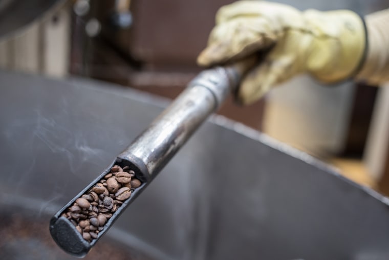 Image: A worker inspects coffee beans in the process of being roasted at the Cafexcoop plant in the town of Sevilla