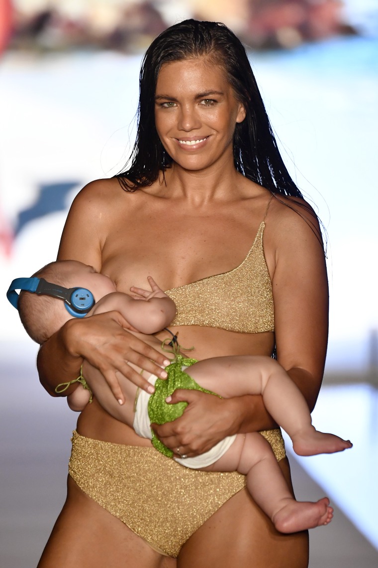 Swimsuit model breastfeeds daughter on the runway cheered on by crowd