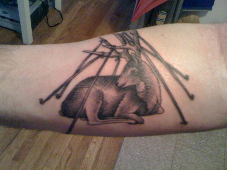 Noah Michelson's first tattoo of a deer tethered to the ground
