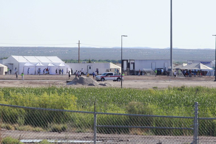 Image: Children of detained migrants play soccer at a newly constructed tent encampment as seen through a border fence near the U.S. Customs and Border Protection port of entry in Tornillo