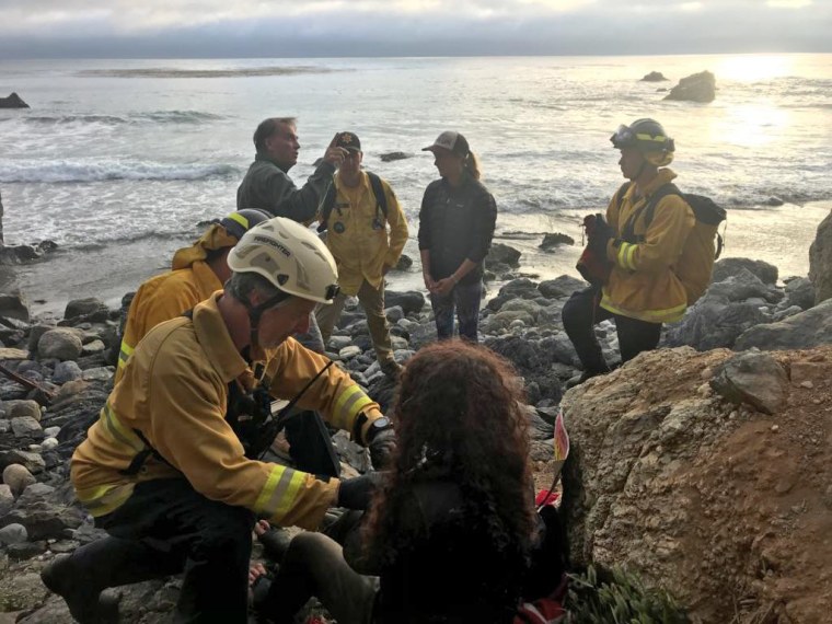Authorities tend to Angela Hernandez, foreground center, after she was rescued in Morro Bay, California.