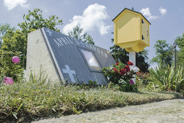 Fresh flowers and balloons decorate April's Garden, a memorial garden for April Tinsely, in Fort Wayne, Indiana.