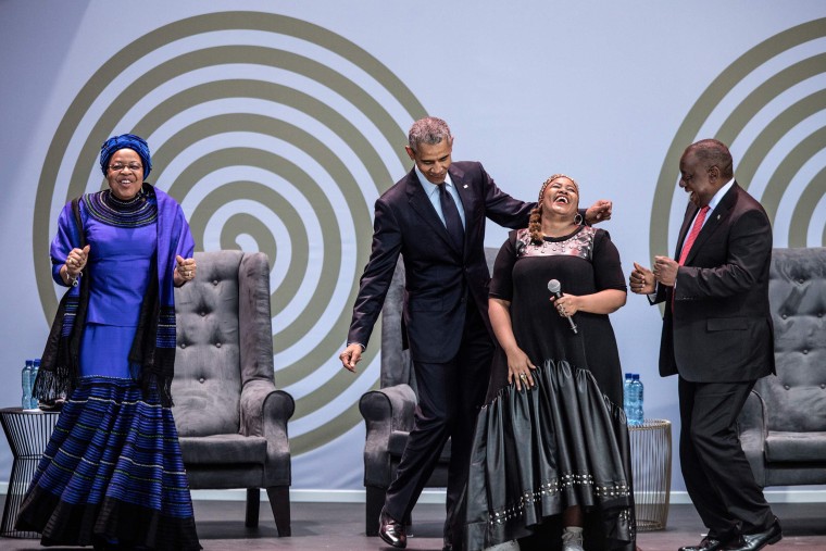 Image: Former U.S. President Barack Obama dances as South-African singer Thandiswa Mazwai performs