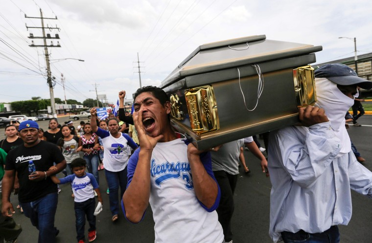 Image: Friends and relatives carry the coffin containing the body of the student Gerald Velazquez