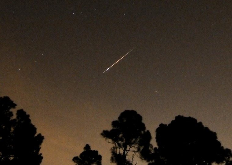 A Perseid meteor streaks towards the horizon during the annual Persied meteor shower in Palm Beach Gardens