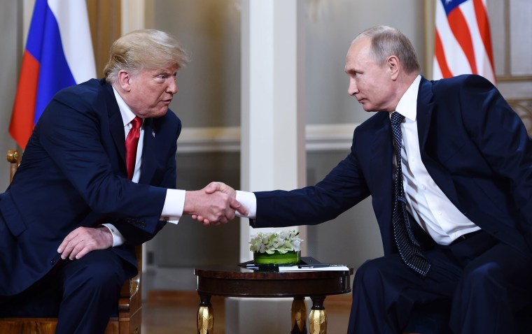 Image: President Donald Trump and Russian leader Vladimir Putin shake hands before a meeting in Helsinki