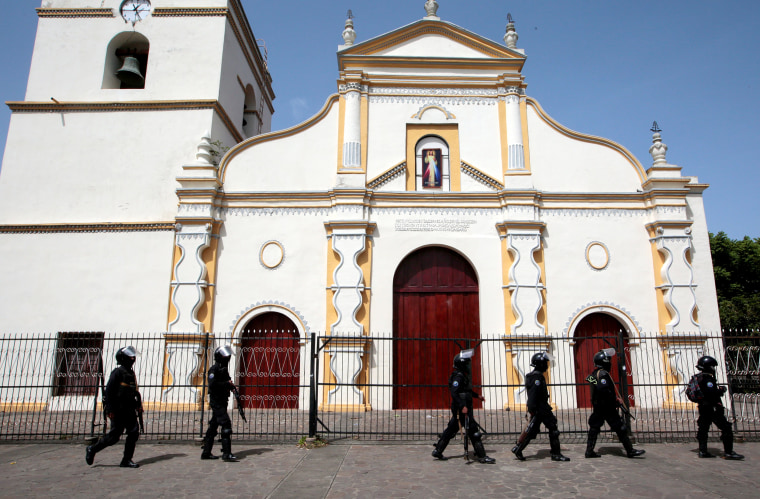 Image: Members of Nicaragua's Special Forces walk past a church during clashes with anti-government protesters in the indigenous community of Monimbo in Masaya