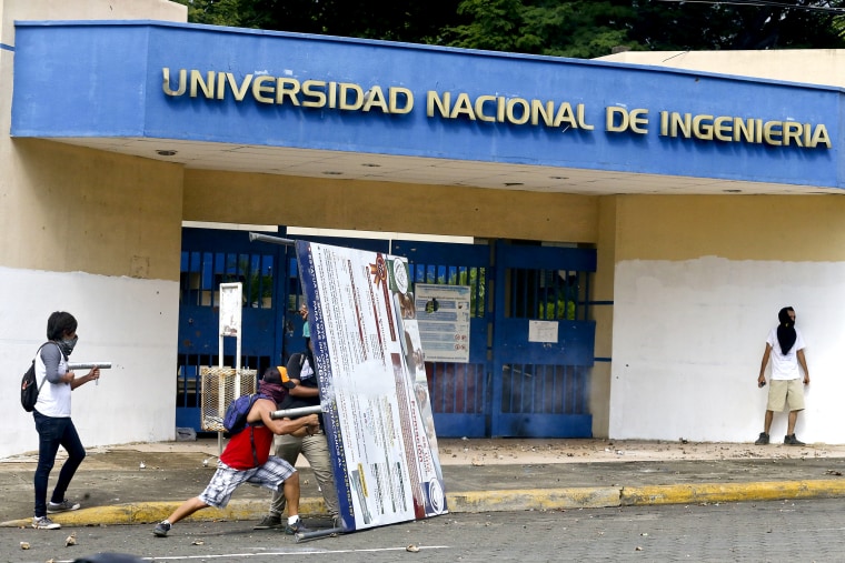 A demonstrator fires a home-made mortar at the police from outside the National Engineering University, during a protest against Nicaragua's President