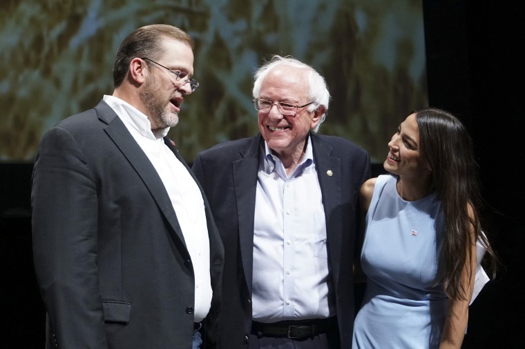 Image: Kansas congressional candidate James Thompson, left, U.S Sen. Bernie Sanders, I-Vt.,  and Alexandria Ocasio-Cortez