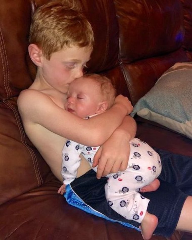 The moment of sweet hugs of a 6-year-old brother for his premature baby