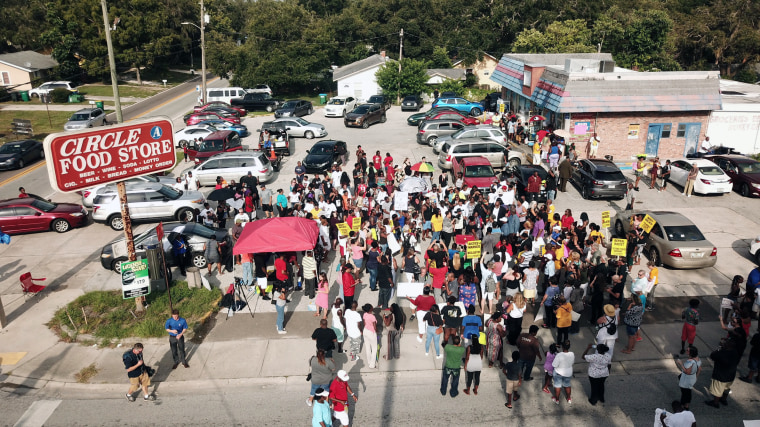 Image: Family, friends and demonstrators gather in a parking lot in Clearwater, Florida
