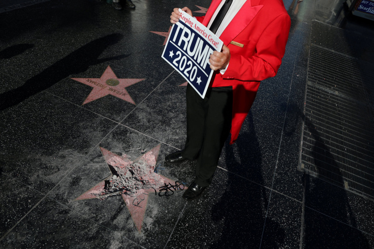Image: Greg Donovan, 58, stands on President Donald Trump's vandalized star on the Hollywood Walk of Fame in Hollywood, Los Angeles