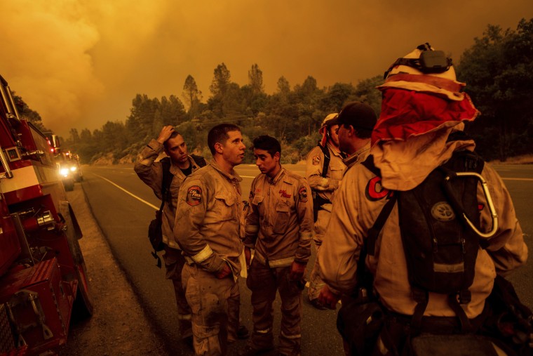 Image: Firefighters discuss plans while battling the Carr Fire in Shasta, California, on July 26, 2018.