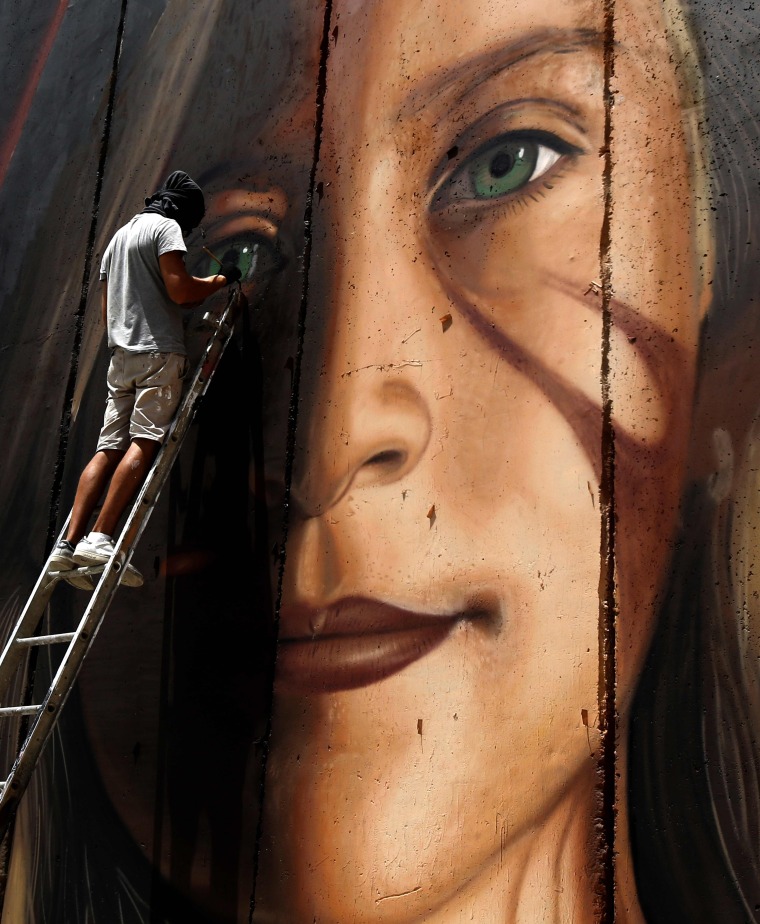 Image: Italian artist Jorit Agoch paints a mural of Ahed Tamim