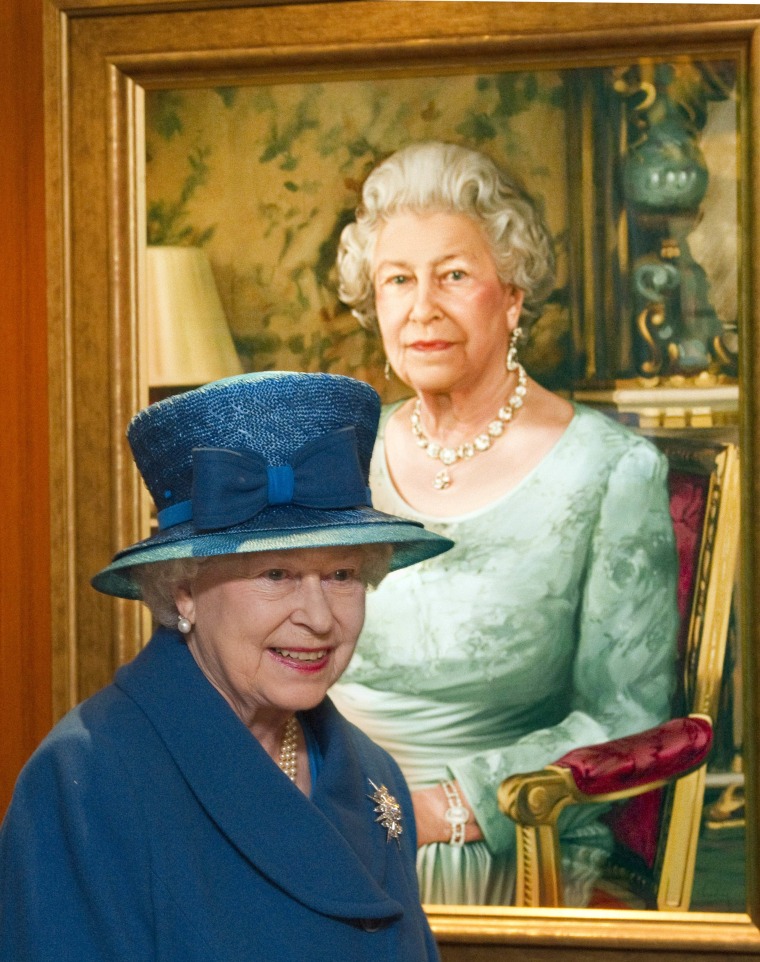 Britain's Queen Elizabeth passes a portrait of herself.FIle