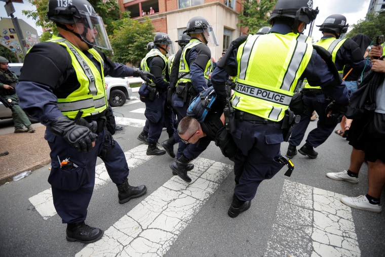 Image: Police carry a protester at the site where Heather Heyer was killedin Charlottesville