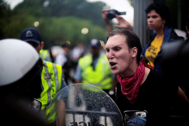 Image: Nadelyn King of Richmond, Virginia, shouts at police officers guarding the White House on Pennsylvania Avenue in Washington