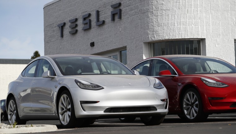 Image: Unsold 2018 Model 3 Long Range vehicles sit on a Tesla dealer's lot