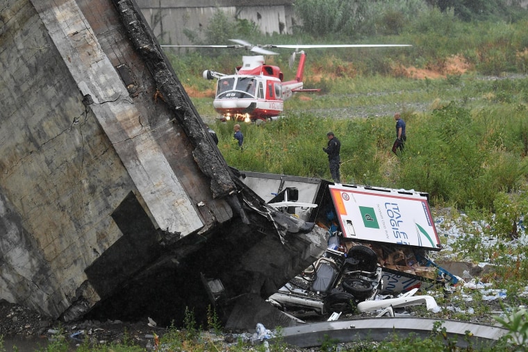 Image: Rescuers scour the debris after the bridge collapsed