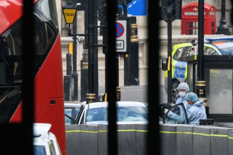 Image: Forensic teams investigate at the scene of a crash in London