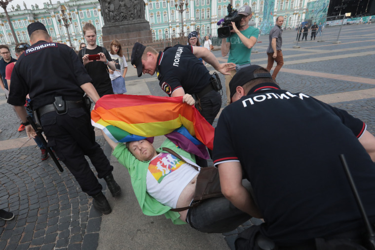 A demonstrator is detained by police during the LGBT community rally in central St. Petersburg, Russia.