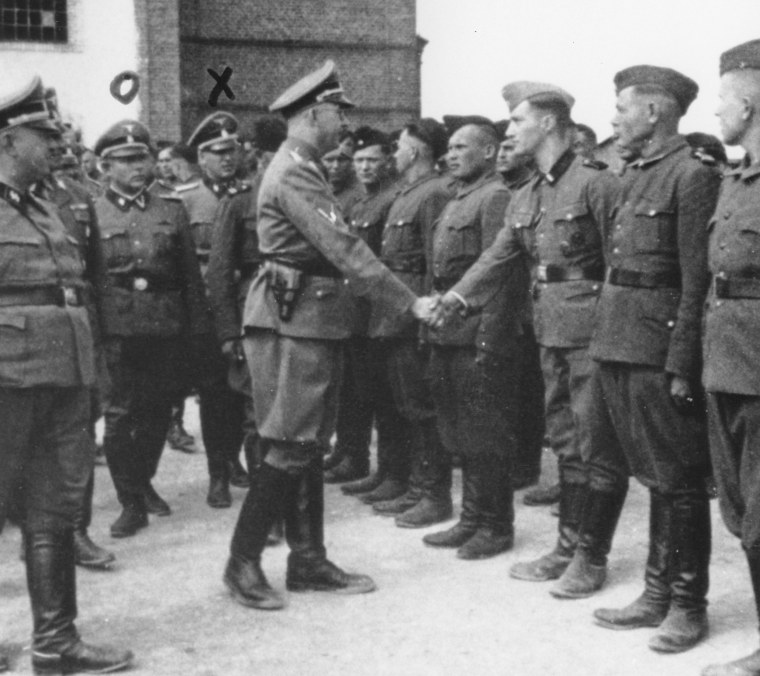 Heinrich Himmler, center left, shaking hands with new guard recruits at the Trawniki concentration camp in Nazi occupied Poland