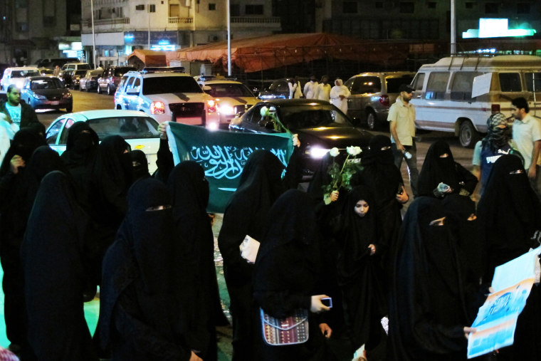 Demonstrators march during a protest in Qatif