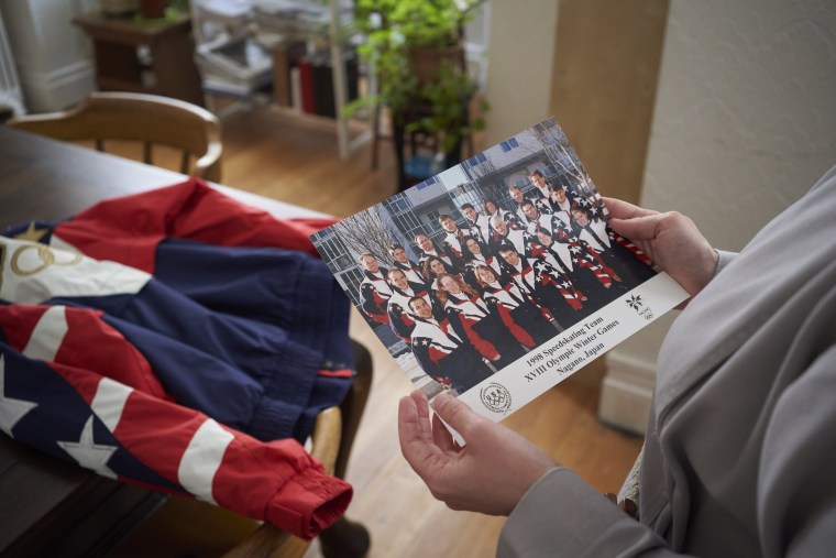 Image: Kirstin Holum, who is now known as Sister Catherine, holds a photo of the 1998 U.S. Olympic speedskating team