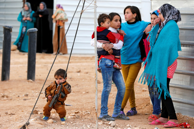 Syrian refugees wait for the arrival of actor Angelina Jolie, UNHCR Special Envoy, at the Al Zaatri refugee camp