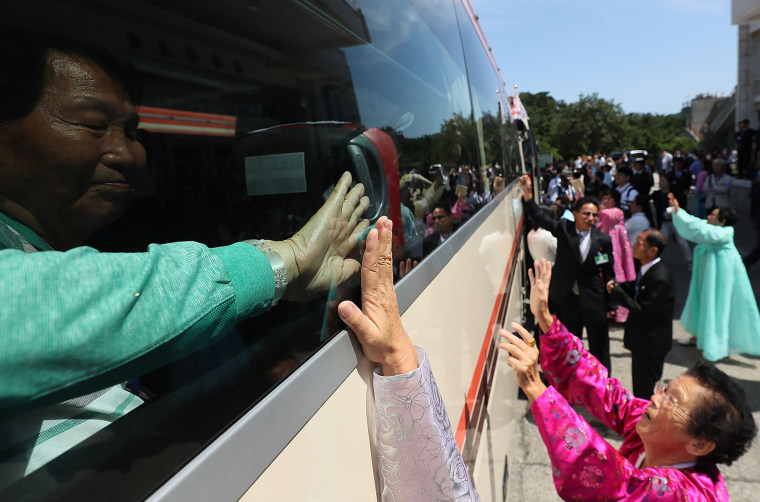 Image: North Koreans wave goodbye to their South Korean family members as they leave a 3-day reunion