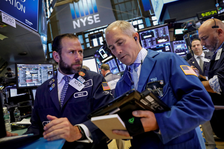 Image: Traders work on the floor of the NYSE in New York