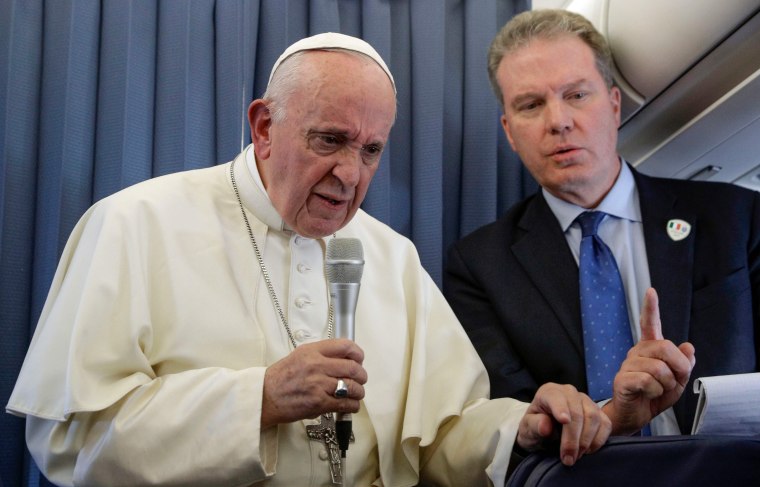 Image: Pope Francis, flanked by Head of the Vatican press office, Greg Burke, addresses reporters during a press conference in flight between Ireland and Rome