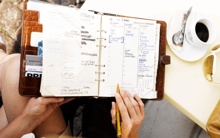 Image: Woman at an outdoor restaurant with her day planner. Image shot 2007. Exact date unknown.