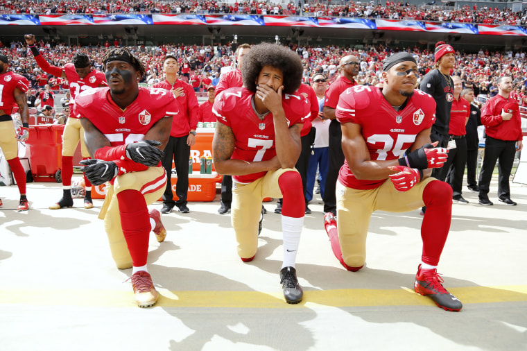 Image: Colin Kaepernick kneels during the national anthem