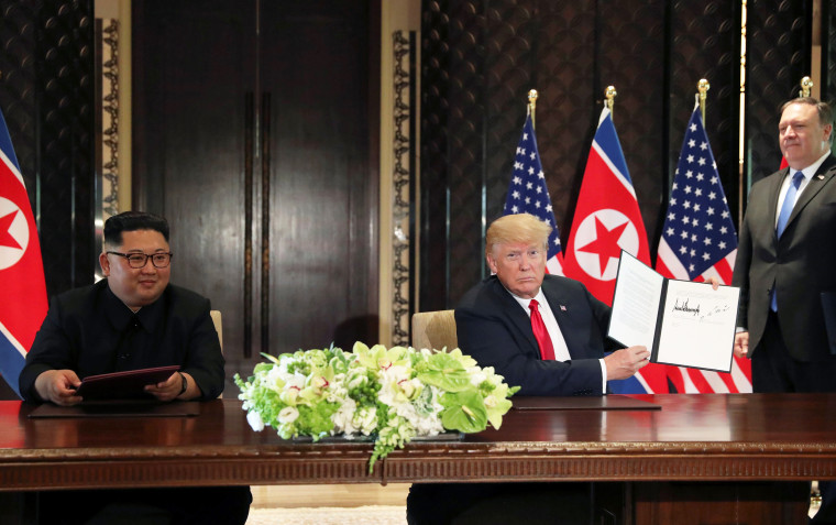U.S. President Donald Trump shows the document, that he and North Korea's leader Kim Jong Un signed at their summit in Singapore