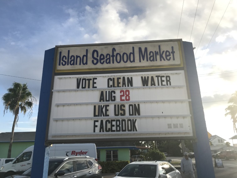 A sign outside the Island Seafood Market in Cape Coral, Florida urges voters to make clean water a ballot box priority in Sunshine State's August 28th primary.