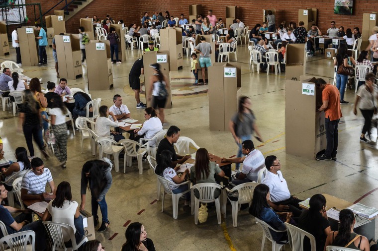 Image: People vote at a polling station in Medellin