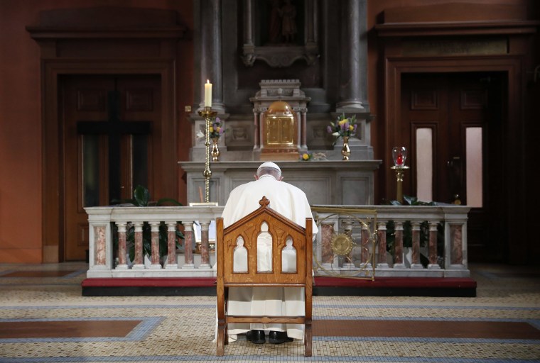 Image: Pope Francis prays inside St Mary's Pro Cathedral