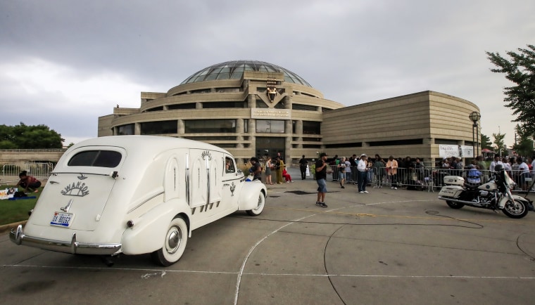 Image: Swanson Funeral Home's 1936 LaSalle hearse is parked outside the Charles H. Wright Museum of African American History