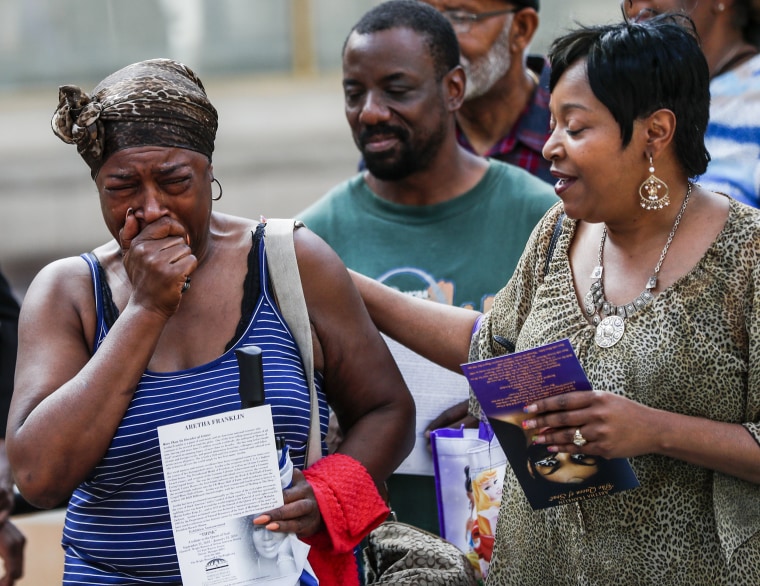 Image: A woman cries as she views the open casket of Aretha Franklin during a public viewing