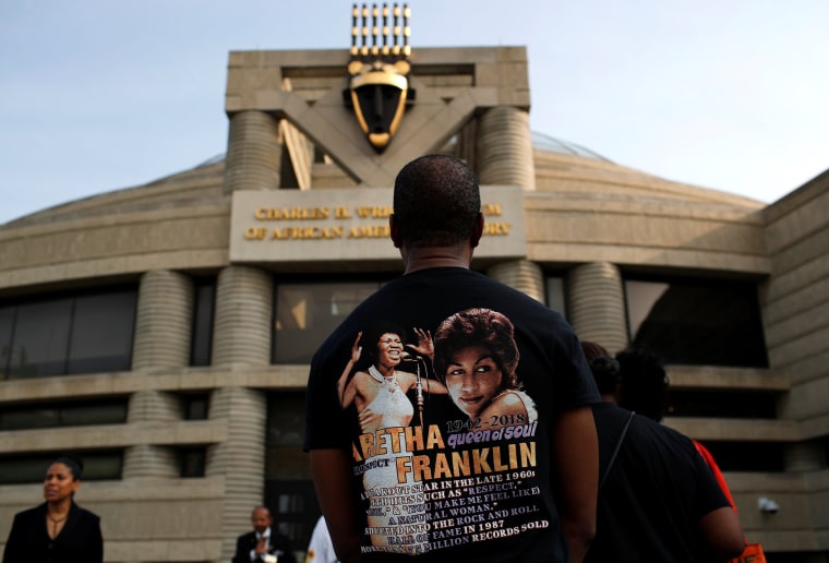 Image: A fan waits outside the Charles H. Wright Museum of African American History