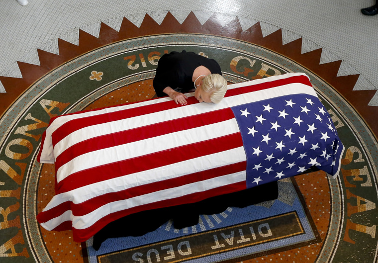 Image: Cindy McCain lays her head on casket of Sen. John McCain