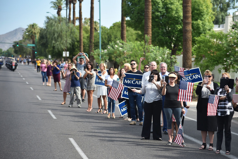 Image: People gather along the street after the memorial service for the late US Senator John McCain