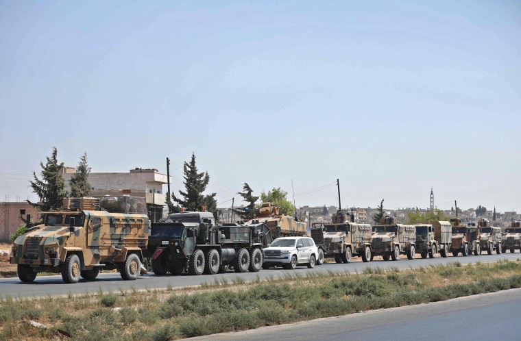 Image: Turkish forces move in a convoy in Syria's Idlib province