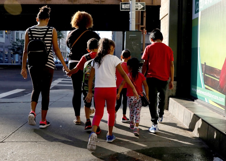 Image: Children are escorted to the Cayuga Center, which provides foster care and other services to immigrant children separated from their families, in New York