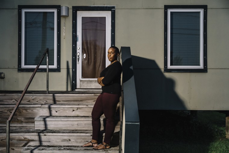 Image: Kamaria Allen stands on the front steps of the home on Reynes Street that she purchased from the Make it Right Foundation