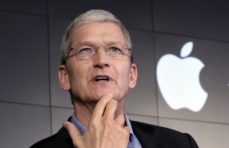 Image: Apple CEO Tim Cook responds to a question during a news conference