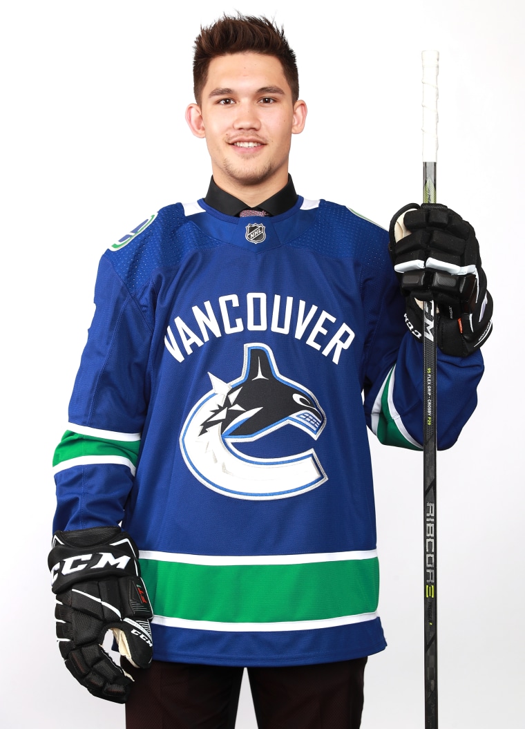 Jett Woo poses after being selected 37th overall by the Vancouver Canucks during the 2018 NHL Draft